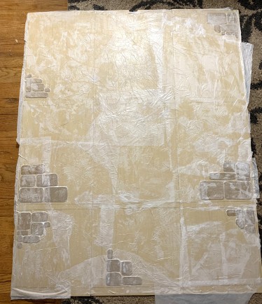 The back panel of a bookcase decoupaged with white tissue paper
